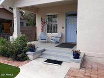 Charming front porch featuring two blue Adirondack chairs, perfect for relaxing outdoors at 711 E Mckinley St, Phoenix, AZ 85006