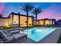 Relaxing backyard with a sparkling pool, lounge chairs, and palm trees, perfect for outdoor enjoyment at 12809 N 67Th St, Scottsdale, AZ 85254