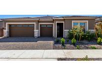 Charming single-story home with brown exterior, landscaped yard, and two-car garage at 24054 N 171St Dr, Surprise, AZ 85387