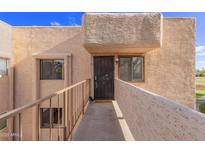 Inviting condo entrance with security door, and walkway overlooking a scenic view at 7061 E Broadway Rd # 48, Mesa, AZ 85208