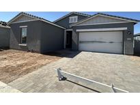 Charming single-story home with a paved driveway and an attached two-car garage at 11422 E Utah Ave, Mesa, AZ 85212