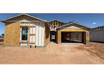 This image shows an exterior view of a house under construction, revealing its framing and initial structure at 11422 E Utah Ave, Mesa, AZ 85212