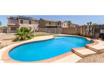 Enjoy this sparkling blue swimming pool, with brick trim and plenty of room for fun at 12825 W Virginia Ave, Avondale, AZ 85392