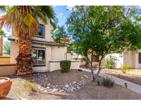 Charming home exterior featuring desert landscaping and a mature palm tree, enhancing curb appeal at 16496 N 68Th Ave, Peoria, AZ 85382