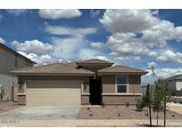 Charming single-Gathering home with a two-car garage and desert landscaping at 17016 W Cavedale Dr, Surprise, AZ 85387