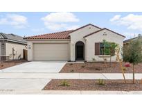 Charming single-story home featuring a red tile roof, stucco exterior, and a two-car garage at 17767 W Getty Dr, Goodyear, AZ 85338