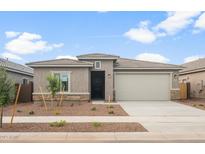 Charming single-story home features a symmetrical design, neutral color palette, and well-manicured xeriscaped front yard at 17770 W Getty Dr, Goodyear, AZ 85338