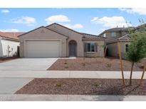 Charming single-story home featuring a two-car garage and low maintenance desert landscaping at 17791 W Getty Dr, Goodyear, AZ 85338