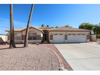 Charming single-story home featuring a well-maintained yard and a spacious three-car garage at 2009 N 125Th Ave, Avondale, AZ 85392