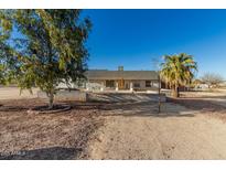 Charming single-story home with desert landscaping and a covered front porch perfect for relaxing at 22324 W Magnolia St, Buckeye, AZ 85326