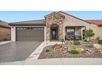 Charming home featuring desert landscaping, stone accents, and a welcoming covered porch at 25920 W Westcott Dr, Buckeye, AZ 85396