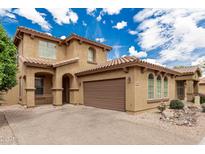Two-story home with a tile roof, a two-car garage, and a charming front porch at 3940 E Geronimo St, Gilbert, AZ 85295
