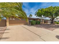Charming single-story home featuring a two-car garage, desert landscaping and mature shade trees at 4158 E Crescent Ave, Mesa, AZ 85206
