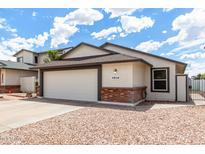 Charming single-story home featuring a spacious two-car garage and low maintenance landscaping at 4319 E Contessa St, Mesa, AZ 85205