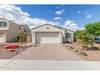 Charming single-story home with a brick driveway, a two-car garage, and desert landscaping at 5312 W Hardtack Trl, Laveen, AZ 85339