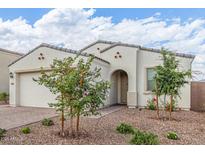 Charming single-story home with a neutral stucco facade, a tiled roof, and low-maintenance desert landscaping at 5312 W Hardtack Trl, Laveen, AZ 85339