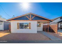 Charming home featuring a striking blue gable, wood accents, and a neatly landscaped front yard at 576 N Pasadena --, Mesa, AZ 85201