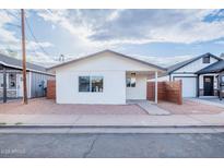 Charming exterior with modern privacy fence and well-maintained front yard landscape, promoting curb appeal at 576 N Pasadena --, Mesa, AZ 85201