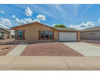 Charming single-story home featuring a two-car garage, low-maintenance landscaping, and a welcoming entrance at 5901 E Leonora St, Mesa, AZ 85215