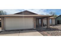 Charming single-story home featuring a two-car garage and covered front porch at 6231 W Zoe Ella Way, Glendale, AZ 85306