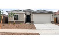 Charming single-story home with a two-car garage, neutral paint, and low-maintenance landscaping at 17761 W Getty Dr, Goodyear, AZ 85338