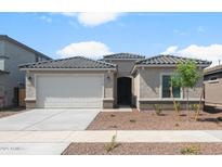 Charming single-story home featuring a two-car garage and desert landscaping at 17776 W Getty Dr, Goodyear, AZ 85338