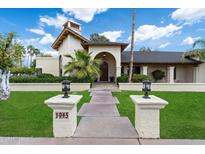 Inviting entrance with meticulously maintained landscaping leading to the front door of the home at 1905 N Calle Maderas --, Mesa, AZ 85213