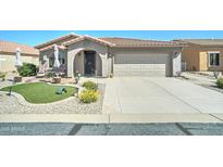 Charming home featuring desert landscaping, a two-car garage, and a welcoming arched entryway and covered porch at 2101 S Meridian Rd # 146, Apache Junction, AZ 85120