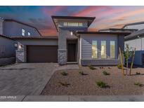 Charming single-Gathering home with a desert landscape and modern architecture, featuring a stone driveway at 21436 W Meadowbrook Ave, Buckeye, AZ 85396