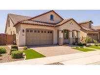 Charming single-story home featuring a tile roof, paver driveway, and manicured landscaping at 23163 E Canary Way, Queen Creek, AZ 85142