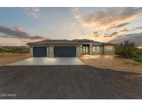 Beautiful home featuring a neutral color scheme, concrete driveway, and three-car garage at 31505 N 166Th Pl, Scottsdale, AZ 85262
