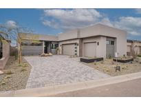 Stunning modern home featuring a desert landscape, two-car garage, and paved driveway at 37200 N Cave Creek Rd # 1019, Scottsdale, AZ 85262