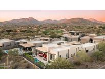 Luxury home with a pool and patio, set against a backdrop of mountains and a golf course at 37200 N Cave Creek Rd # 1034, Scottsdale, AZ 85262
