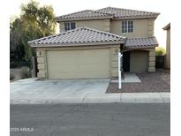 Two-story home featuring a 2-car garage, desert landscaping, and a tile roof at 4136 N 113Th Dr, Phoenix, AZ 85037