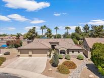 Charming single-story home with a well-manicured front yard, desert landscaping, and a three-car garage at 5410 E Gable Ave, Mesa, AZ 85206