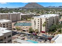 Stunning aerial view of Scottsdale property with pool, tennis court, and mountain views at 7840 E Camelback Rd # 111, Scottsdale, AZ 85251