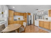 Bright kitchen features wood cabinets, stainless steel appliances, and adjacent dining area at 8103 E Southern Ave # 222, Mesa, AZ 85209