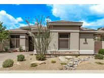 Charming single-story home with desert landscaping and a neutral color palette under a beautiful blue sky at 8220 E Mohawk Ln, Scottsdale, AZ 85255