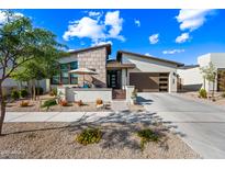 Charming single-Gathering home featuring a landscaped front yard and an attached two-car garage at 830 E Buist Ave, Phoenix, AZ 85042
