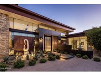Striking modern home featuring a unique water feature and desert landscaping at the front entrance at 10283 E Running Deer Trl, Scottsdale, AZ 85262