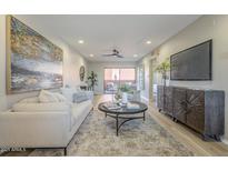Bright living room features a comfortable couch, stylish decor, and sliding doors to the outdoor patio at 12222 N Paradise Vlg S Pkwy # 237, Phoenix, AZ 85032