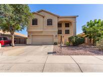 Two-story home with a two-car garage, neutral colors, and low-maintenance desert landscaping at 12571 W Clarendon Ave, Avondale, AZ 85392