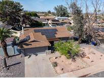 Charming single-Gathering home with desert landscaping and solar panels on the roof at 1720 E Intrepid Ave, Mesa, AZ 85204