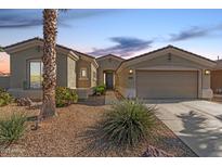 Charming single-story home featuring a well-manicured front yard and inviting entryway at 17517 W Dahlia Dr, Surprise, AZ 85388