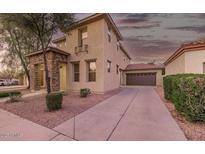 Charming two-story home with a stone-accented porch and a long driveway leading to a detached garage at 3272 E Tyson St, Gilbert, AZ 85295