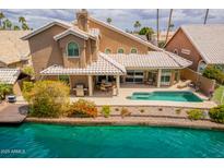 Inviting backyard with a private pool, covered patio, and direct access to the serene waterfront at 518 S Bay Shore Blvd, Gilbert, AZ 85233
