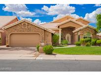 Charming single-story home featuring a stone-accented facade, tile roof, and well-manicured landscaping at 518 S Bay Shore Blvd, Gilbert, AZ 85233