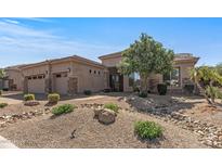 Single-story home with desert landscaping, a stone-accented facade, and a three-car garage at 5813 E Ashler Hills Dr, Cave Creek, AZ 85331