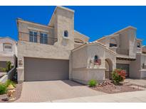 Beautiful home featuring desert landscaping, a two-car garage, and unique architectural details at 8149 N 13Th Pl, Phoenix, AZ 85020
