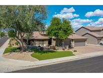 Charming single-story home featuring a well-manicured lawn and a paver driveway at 8654 W Melinda Ln, Peoria, AZ 85382